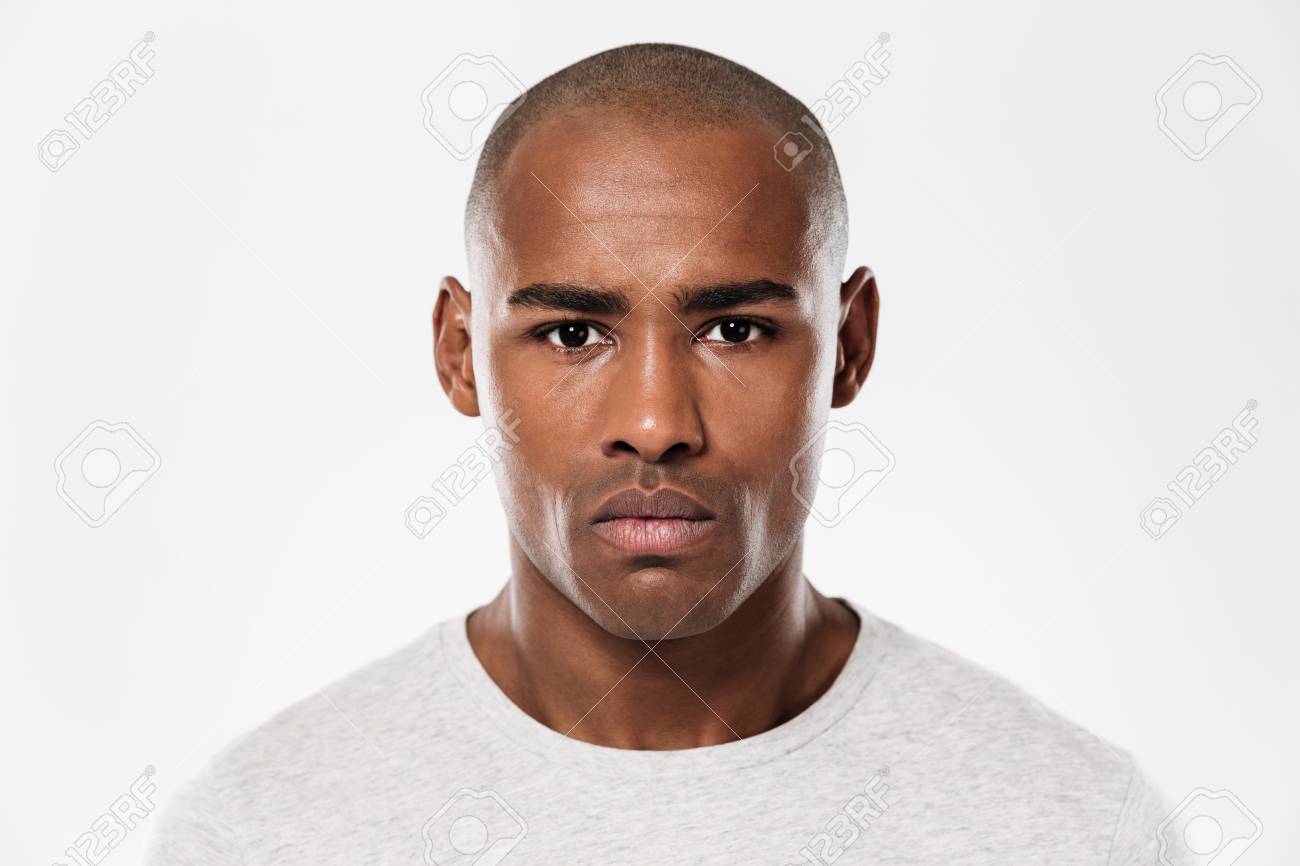 87985431 image of serious young african man standing isolated over white background looking ca
