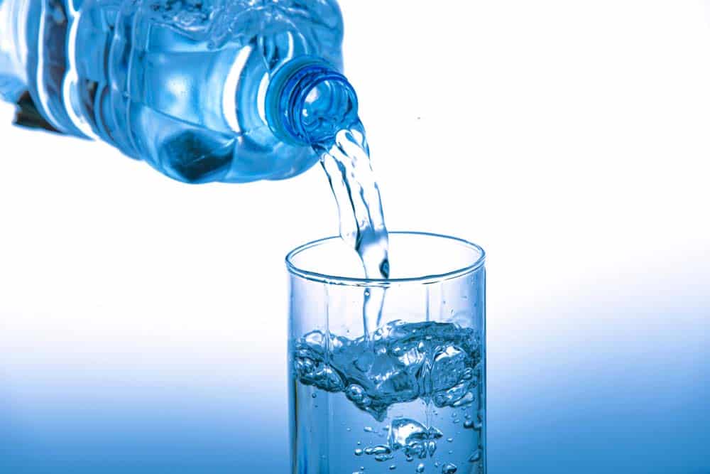 Pouring a fresh and clean water into the glass