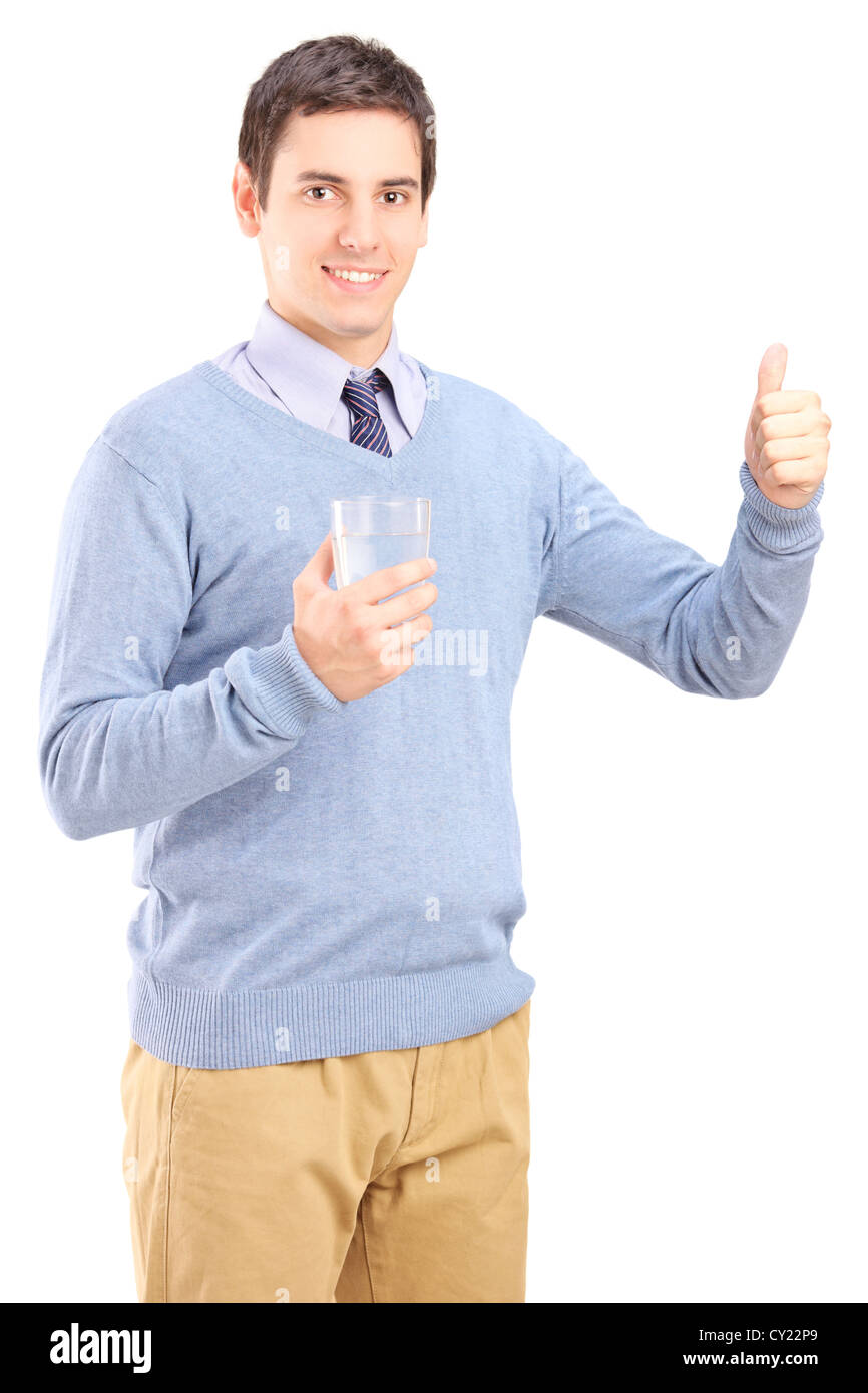 Casual guy holding a glass of water and giving thumb up isolated on CY22P9
