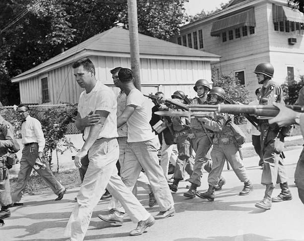 Three men from the mob around little rocks central high school are driven from the area at