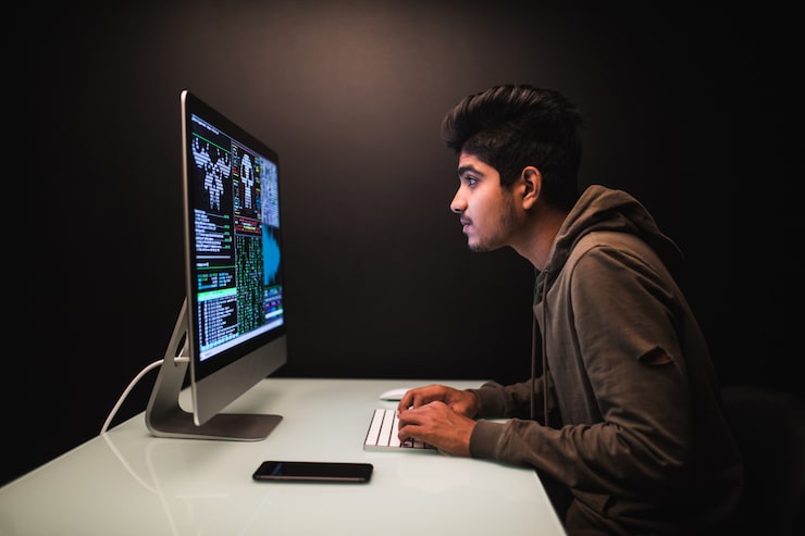 Indian hacker using computers stealing data desk dark 231208 3618