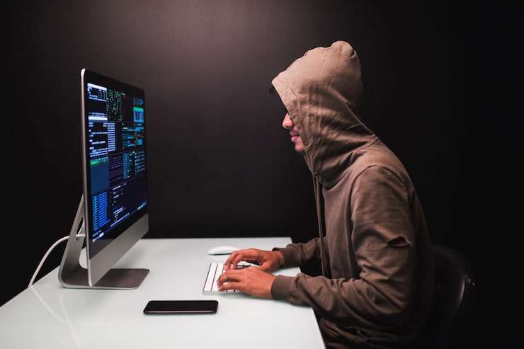 Young male hacker dark room writing code using computer virus program cyber attack 231208 3630
