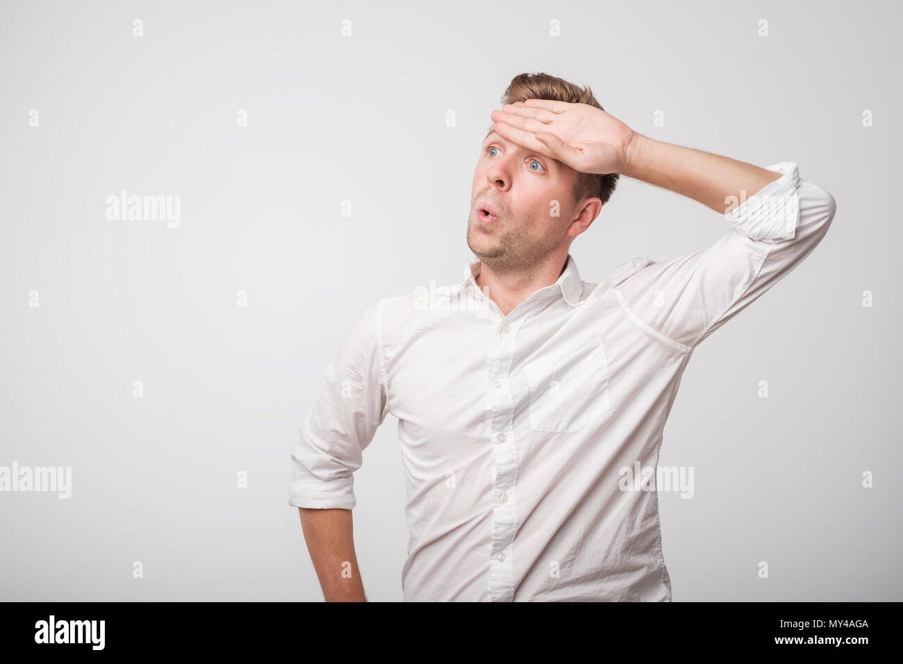 Tired caucasian man in white shirt sweating having fever headache MY4AGA