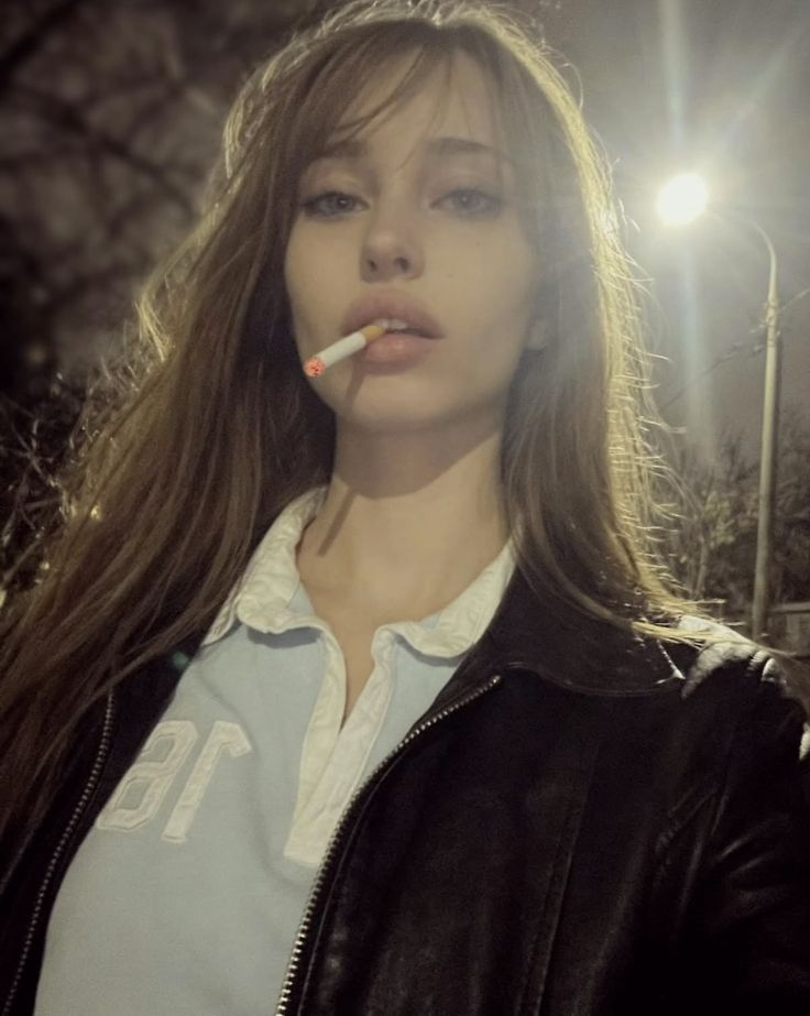 Brunette under light with cig