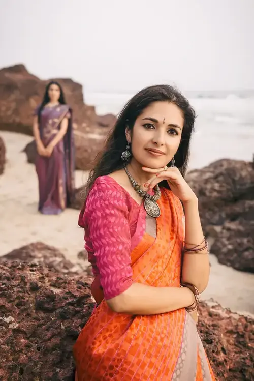 indian-woman-beautiful-saree-fashion-shoot-women-traditional-clothes-standing-rock-near-beach...webp