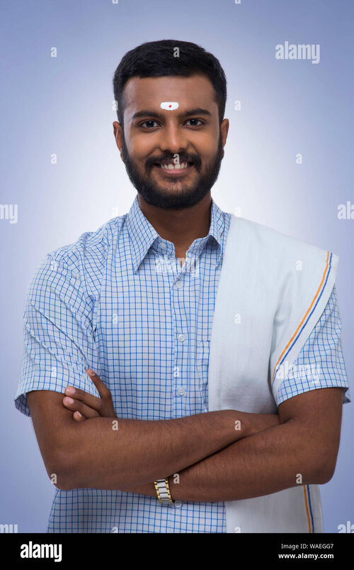 portrait-of-a-south-indian-man-smiling-at-the-camera-WAEGG7.jpg